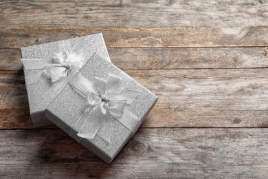 Photo of Beautiful gift boxes on wooden background