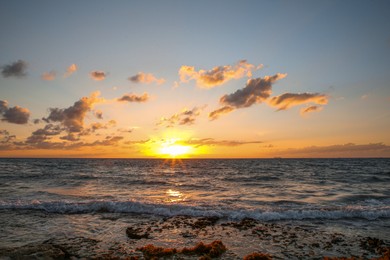 Photo of Picturesque view of sea under sky at beautiful sunset