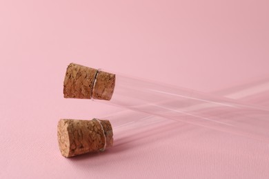Photo of Test tubes on pink background, closeup. Laboratory glassware