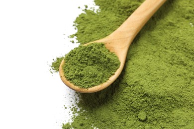 Green matcha powder and wooden spoon isolated on white