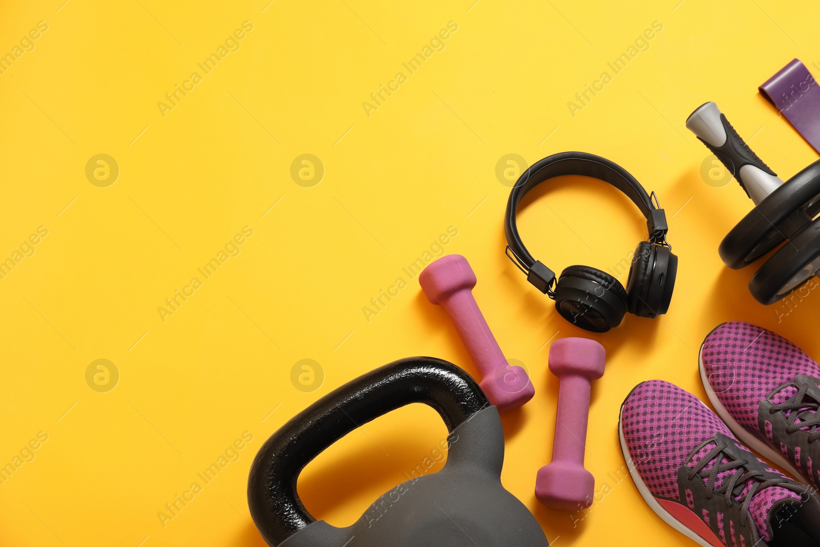 Photo of Different sports equipment on yellow background, flat lay. Space for text