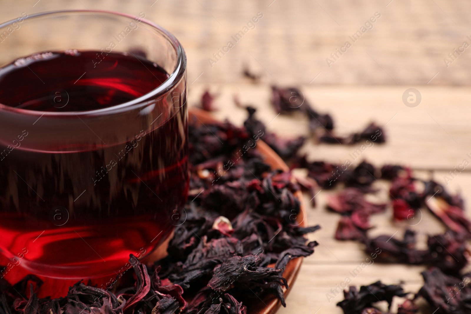 Photo of Fresh Hibiscus tea on wooden table, closeup