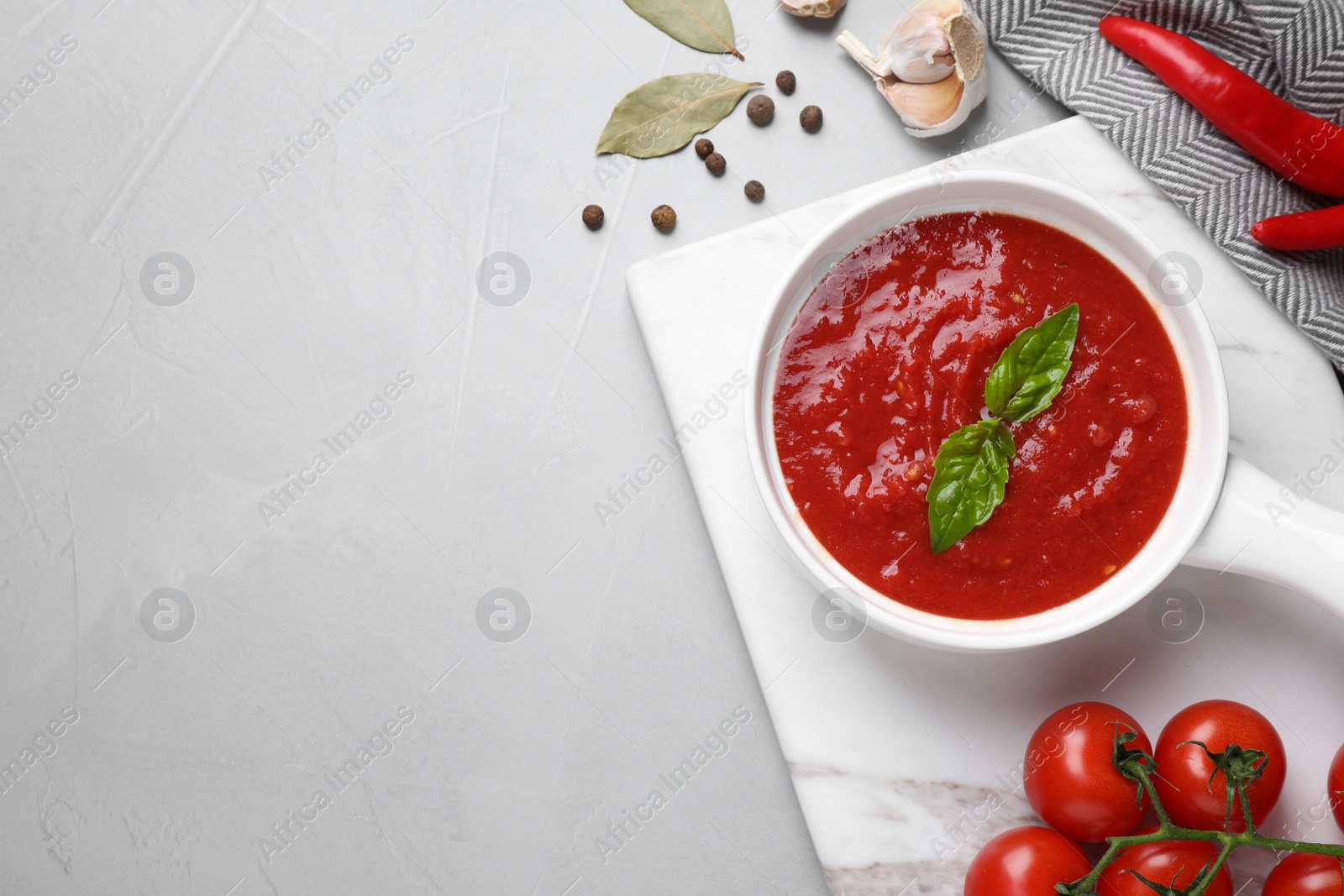 Photo of Delicious tomato sauce on light grey table, flat lay. Space for text