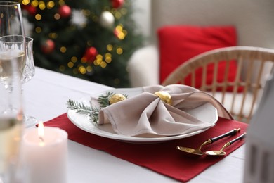 Photo of Christmas table setting with beautiful napkin, cutlery and dishware, closeup