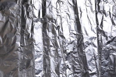 Photo of Crumpled silver foil as background, closeup view