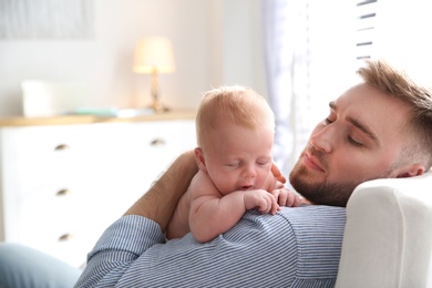 Father with his newborn son at home