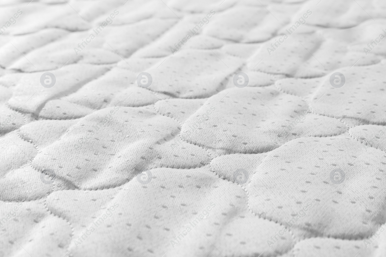 Photo of New light green mattress as background, closeup