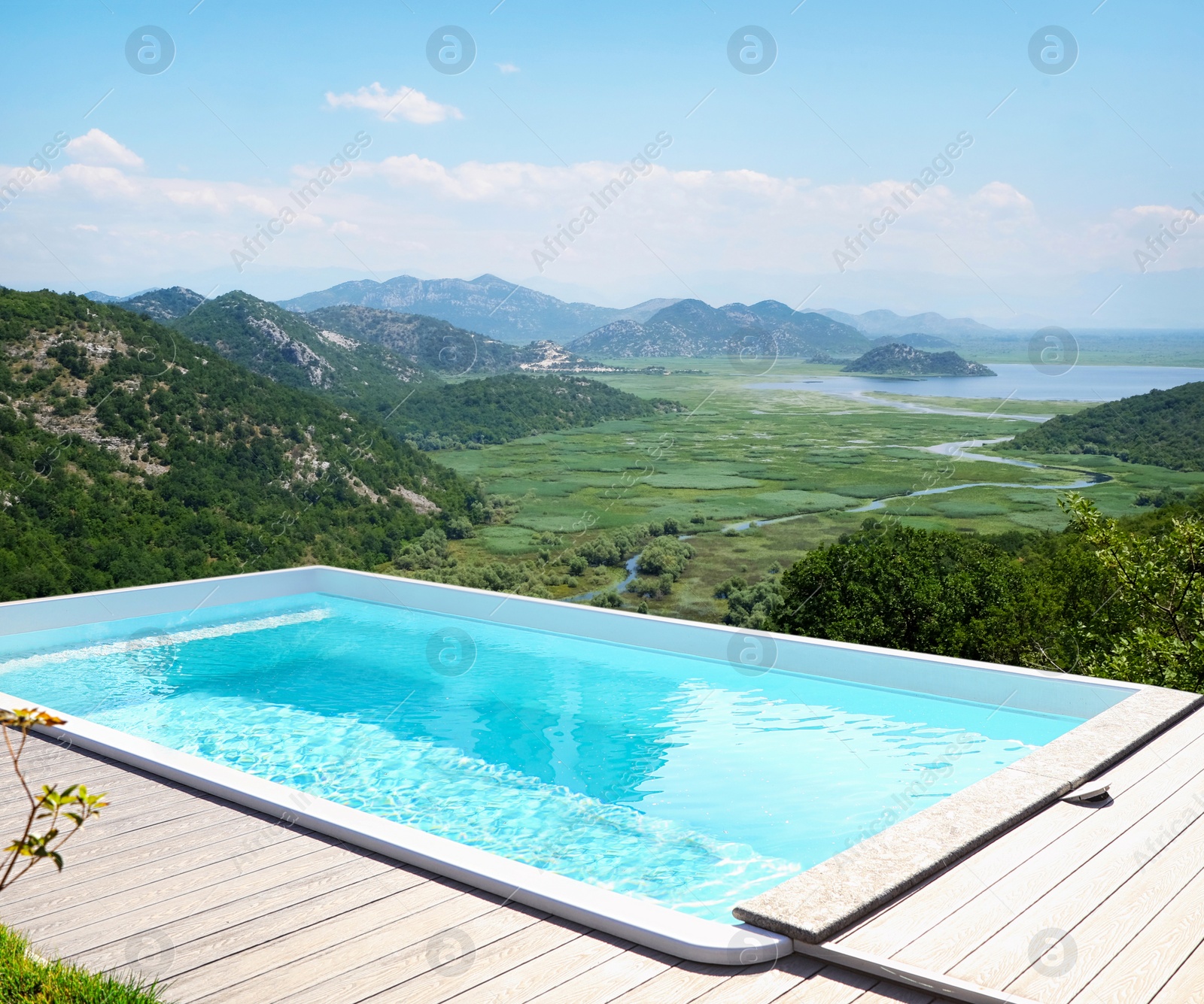 Image of Outdoor swimming pool at luxury resort and beautiful view of mountains on sunny day