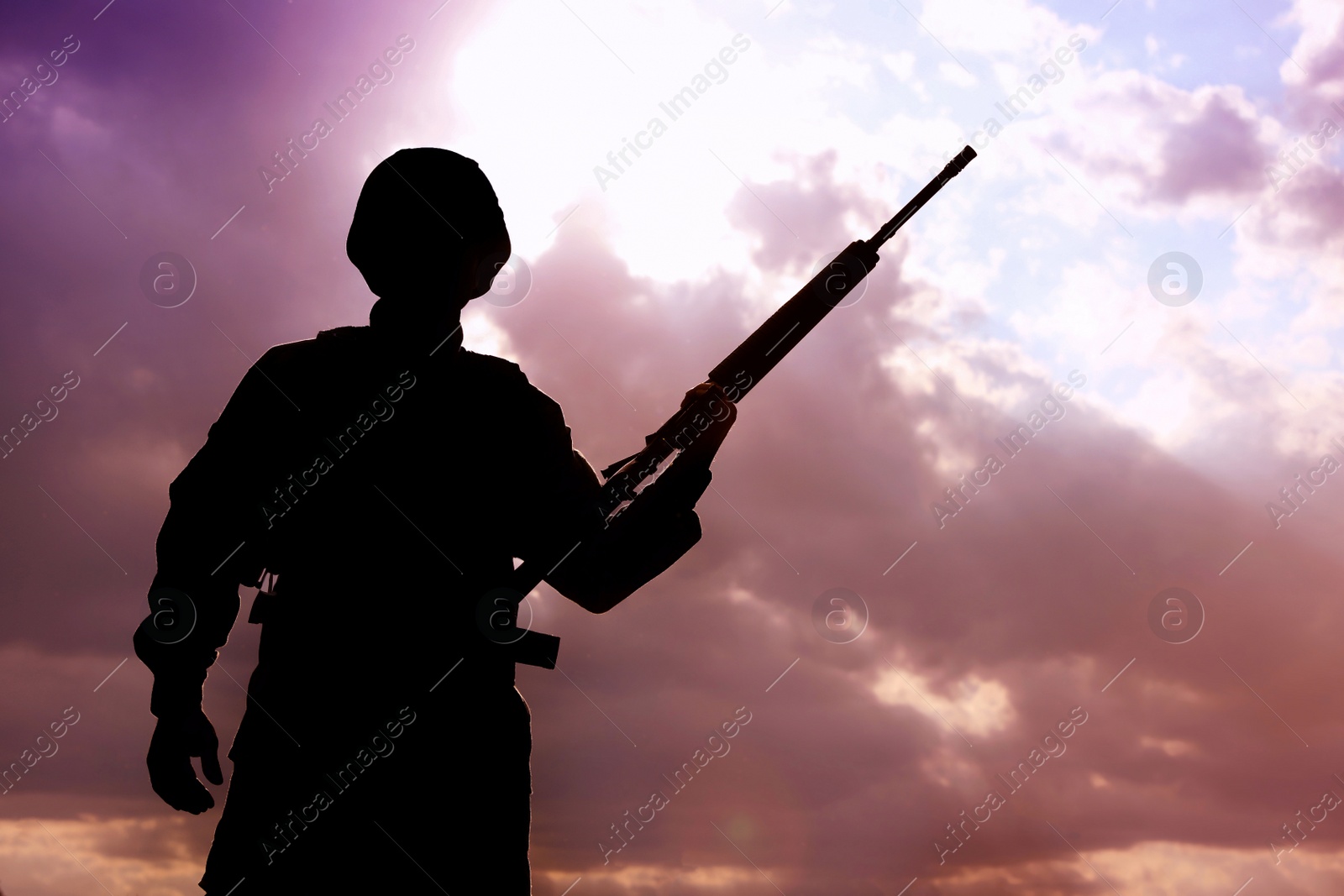 Photo of Soldier with machine gun patrolling outdoors. Military service