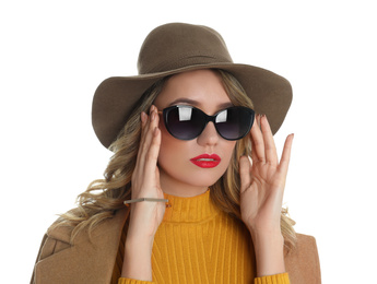 Young woman wearing stylish sunglasses and hat on white background