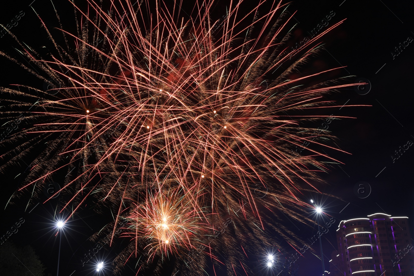 Photo of Beautiful fireworks lighting up night sky outdoors