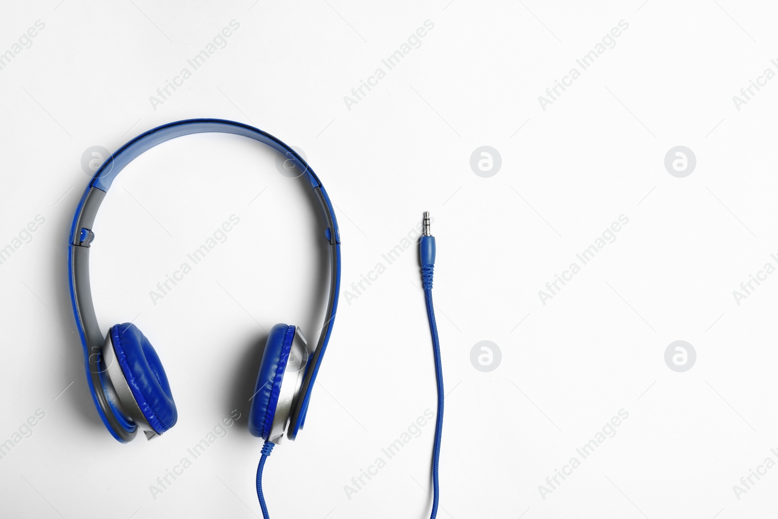 Photo of Stylish modern headphones on white background, top view