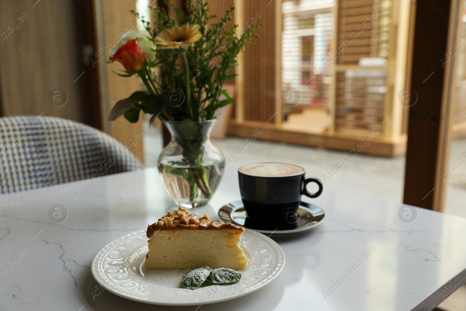 Photo of Tasty dessert and cup of fresh coffee on table in cafeteria