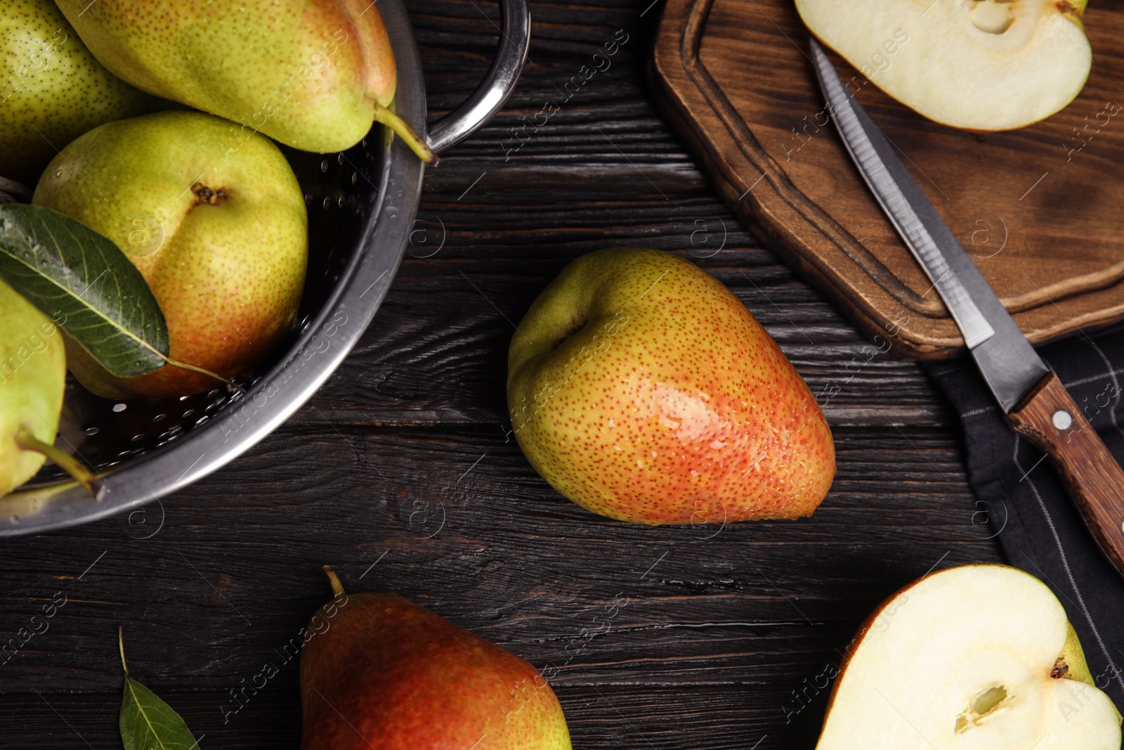 Photo of Ripe juicy pears on black wooden table, flat lay