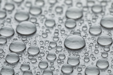 Photo of Water drops on grey background, closeup view