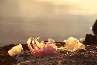 Photo of Plastic garbage at beach, space for text. Environmental pollution concept