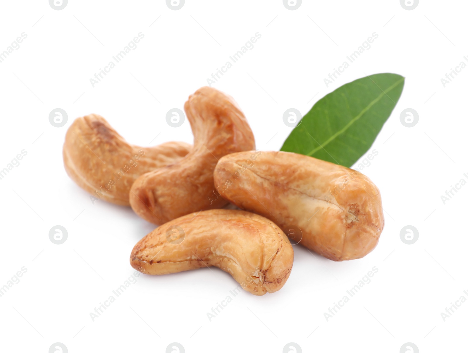 Photo of Tasty organic cashew nuts and green leaf isolated on white