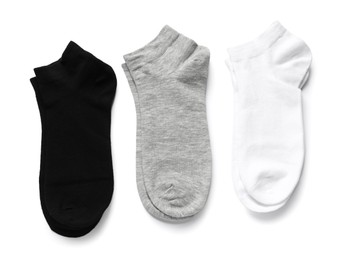 Photo of Different pairs of socks isolated on white, top view