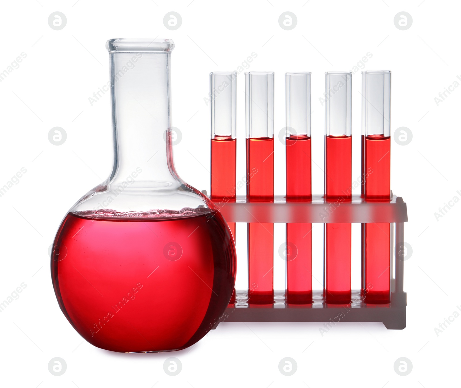 Photo of Set of laboratory glassware with red liquid on white background