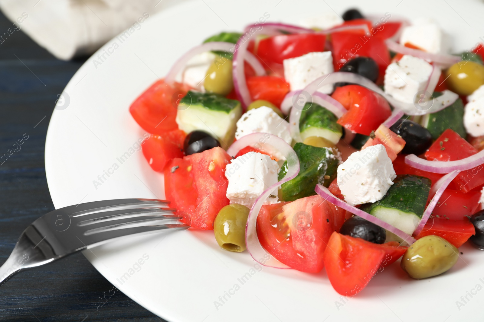 Photo of Plate with delicious salad on table, closeup