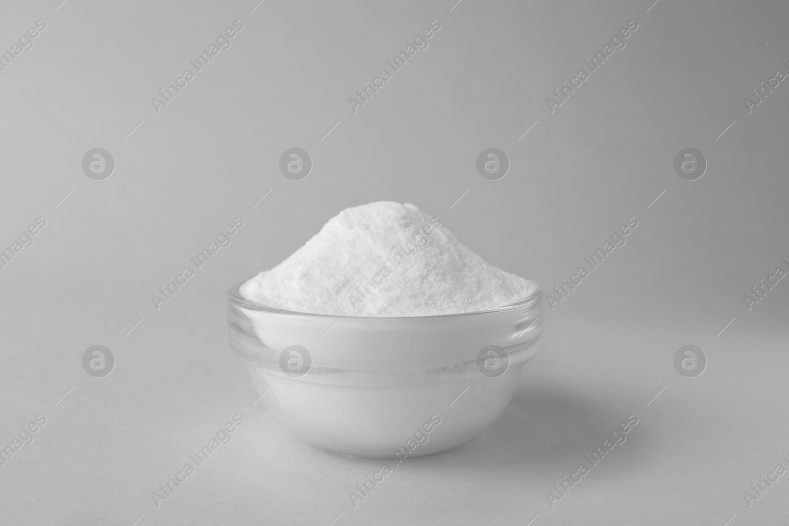 Photo of Bowl of sweet fructose powder isolated on white