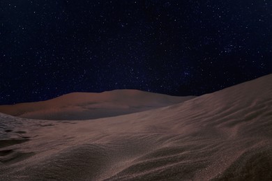 Image of Scenic view of sandy desert under starry sky in night 