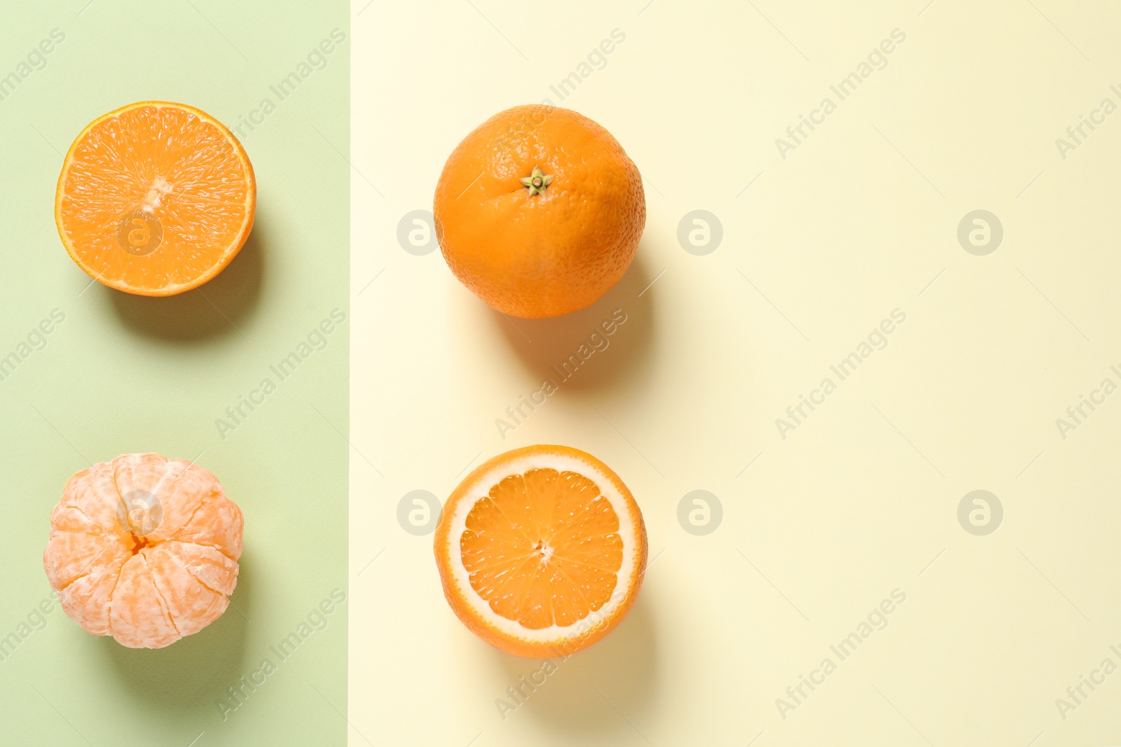 Photo of Flat lay composition with ripe oranges and space for text on color background