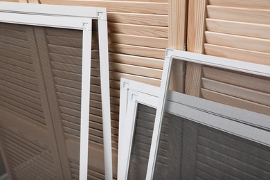 Photo of Set of window screens near wooden folding screen