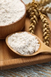 Photo of Organic wheat flour on wooden table, closeup