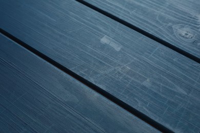 Old blue wooden surface with scratches as background, closeup