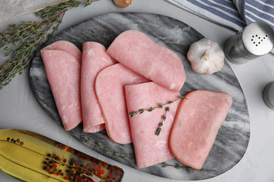 Photo of Tasty ham served on light grey table, flat lay