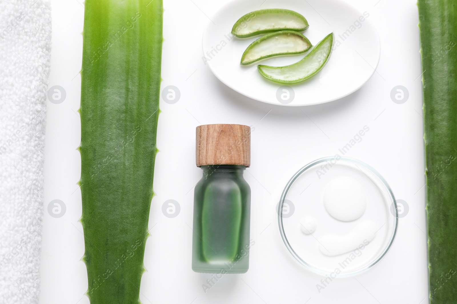 Photo of Flat lay composition with cosmetic products and cut aloe leaves on white background