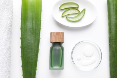 Flat lay composition with cosmetic products and cut aloe leaves on white background