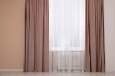 Photo of Window with beautiful curtains in room. Interior design
