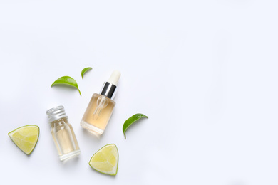 Photo of Composition with lime essential oil on white background, top view