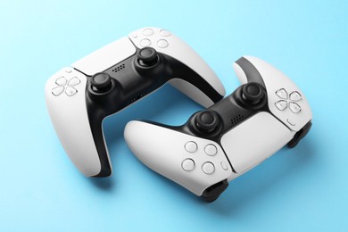 Wireless game controllers on light blue background