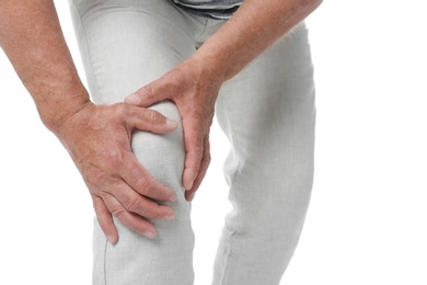 Senior man having knee problems on white background, closeup