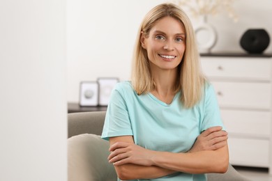 Photo of Portrait of beautiful woman with blonde hair. Attractive lady smiling and looking into camera. Space for text