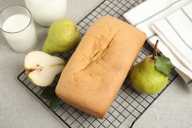 Photo of Tasty bread and pears on light grey table. Homemade cake