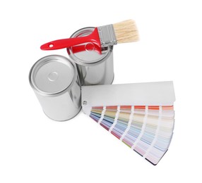 Photo of Cans of paints, brush and color palette on white background