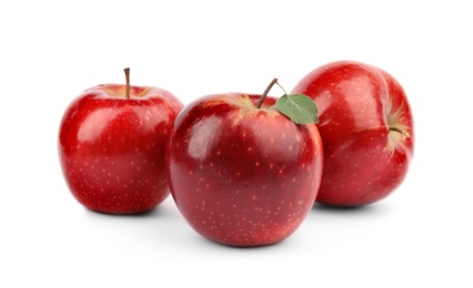 Ripe juicy red apples with leaf on white background