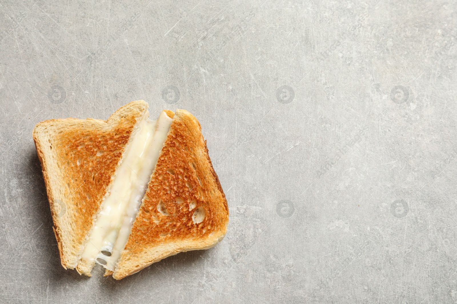 Photo of Fresh cheese sandwiches on grey table, top view. Space for text