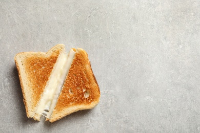 Photo of Fresh cheese sandwiches on grey table, top view. Space for text