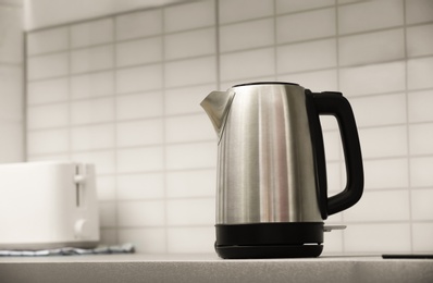 Photo of Modern electric kettle and toaster on grey kitchen counter. Space for text