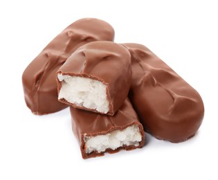 Photo of Delicious milk chocolate candy bars with coconut filling on white background