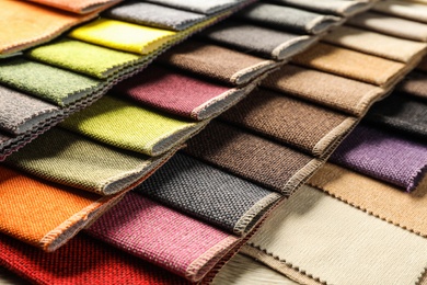 Photo of Fabric samples of different colors for interior design as background