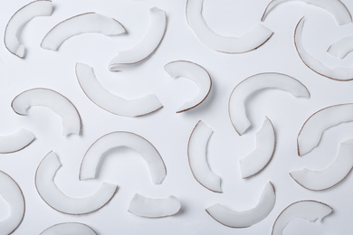 Photo of Fresh coconut flakes on white background, top view