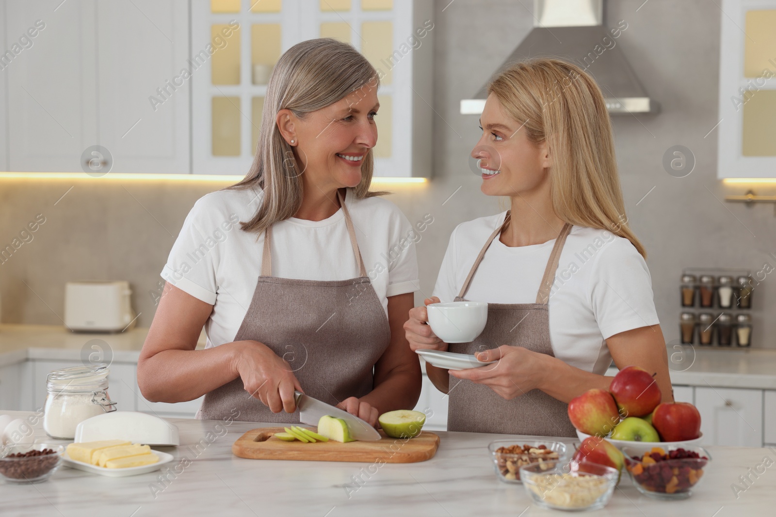 Photo of Happy mature mother with her daughter at kitchen