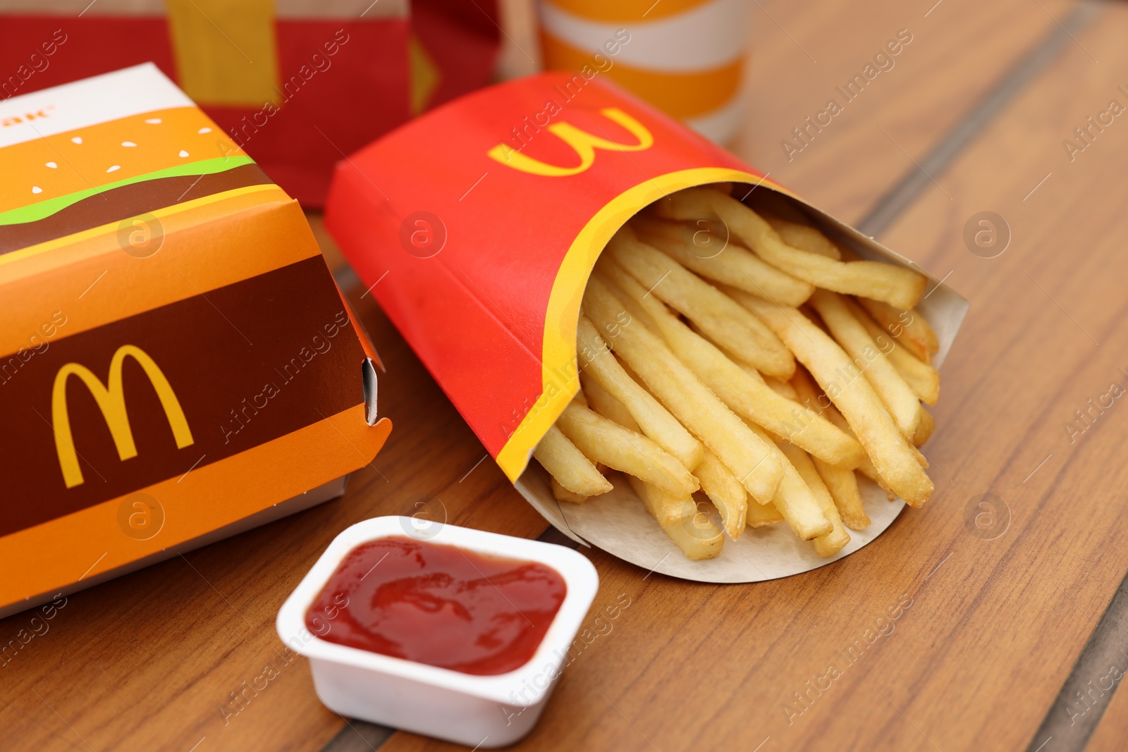 Photo of Lviv, Ukraine - October 9, 2023: McDonald's menu on wooden table outdoors, closeup