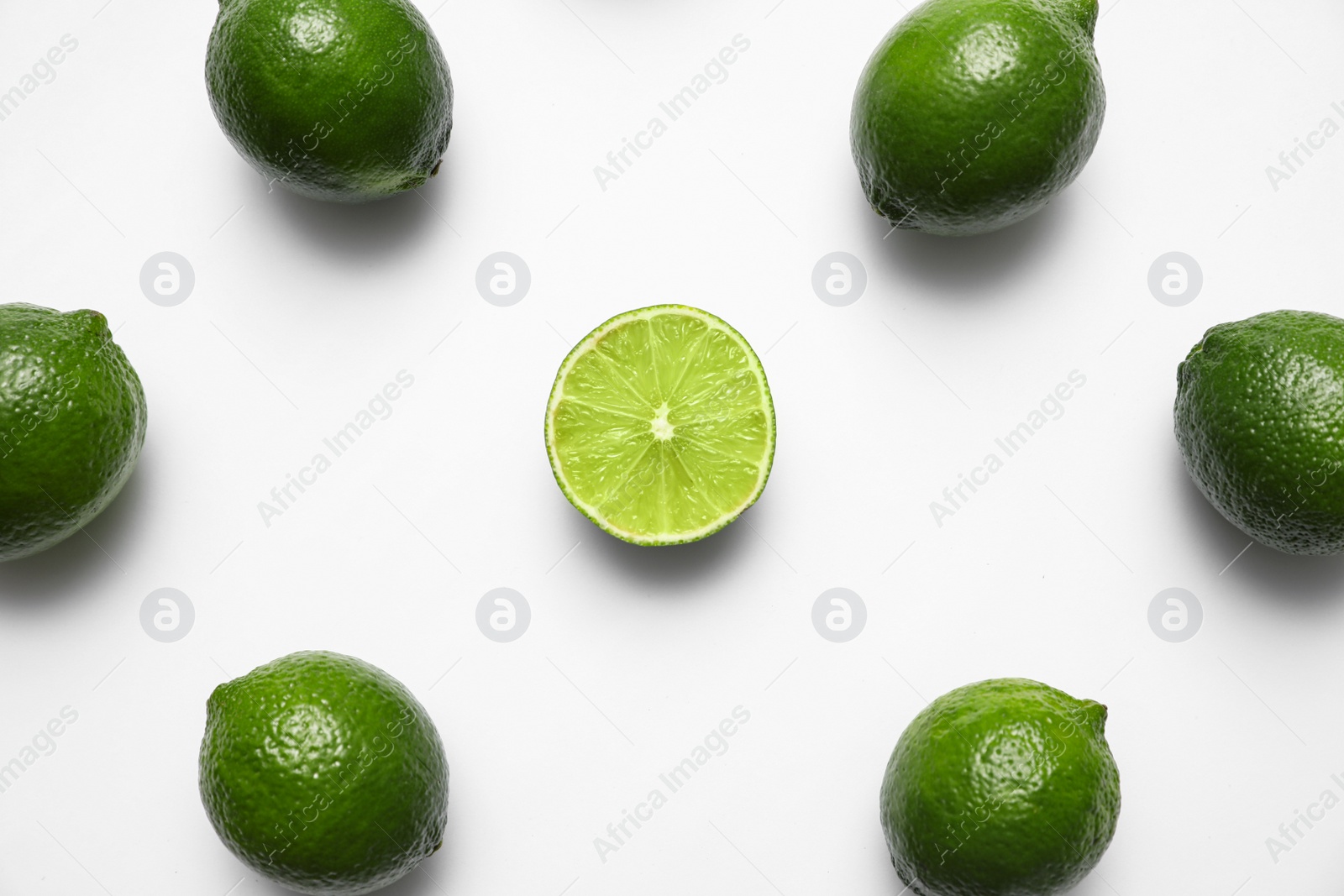 Photo of Flat lay composition with fresh juicy limes on white background